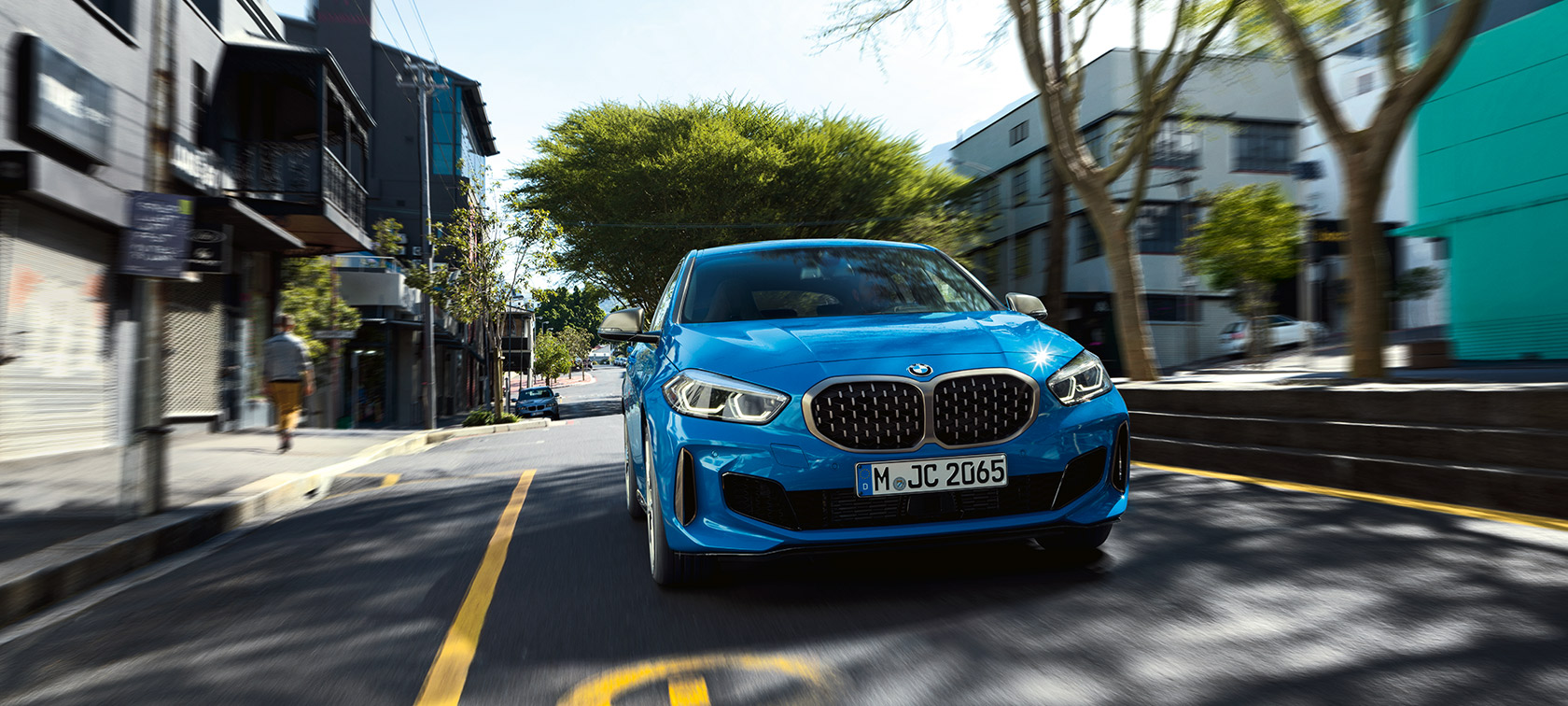 BMW 1 Series F40 in Misano Blue metallic, front view driving