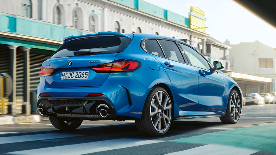 BMW 1 Series F40, three-quarter rear view driving BMW 1 Series F40 in Misano Blue metallic, three-quarter rear view driving