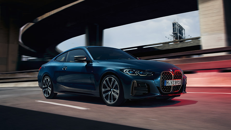 BMW 4 Series Coupé G22 three-quarter side view on the road BMW 4 Series BMW 4 Series Coupé G22 second generation three-quarter side view on the road