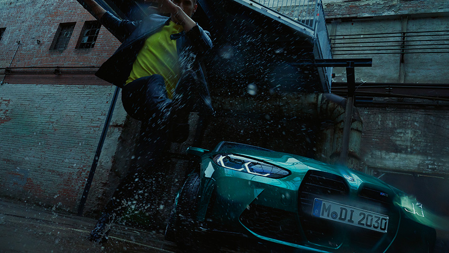 BMW M3 Sedan G80 2020 Isle of Man Green metallic front view with man in the rain