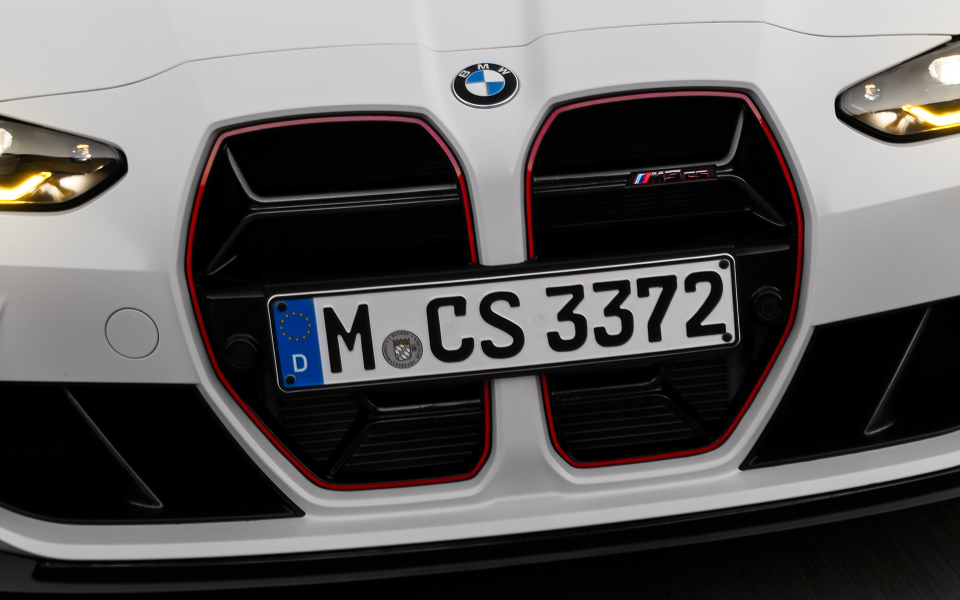 BMW M3 CS G80 CS specific kidney grille in black with red special model signature front view driving