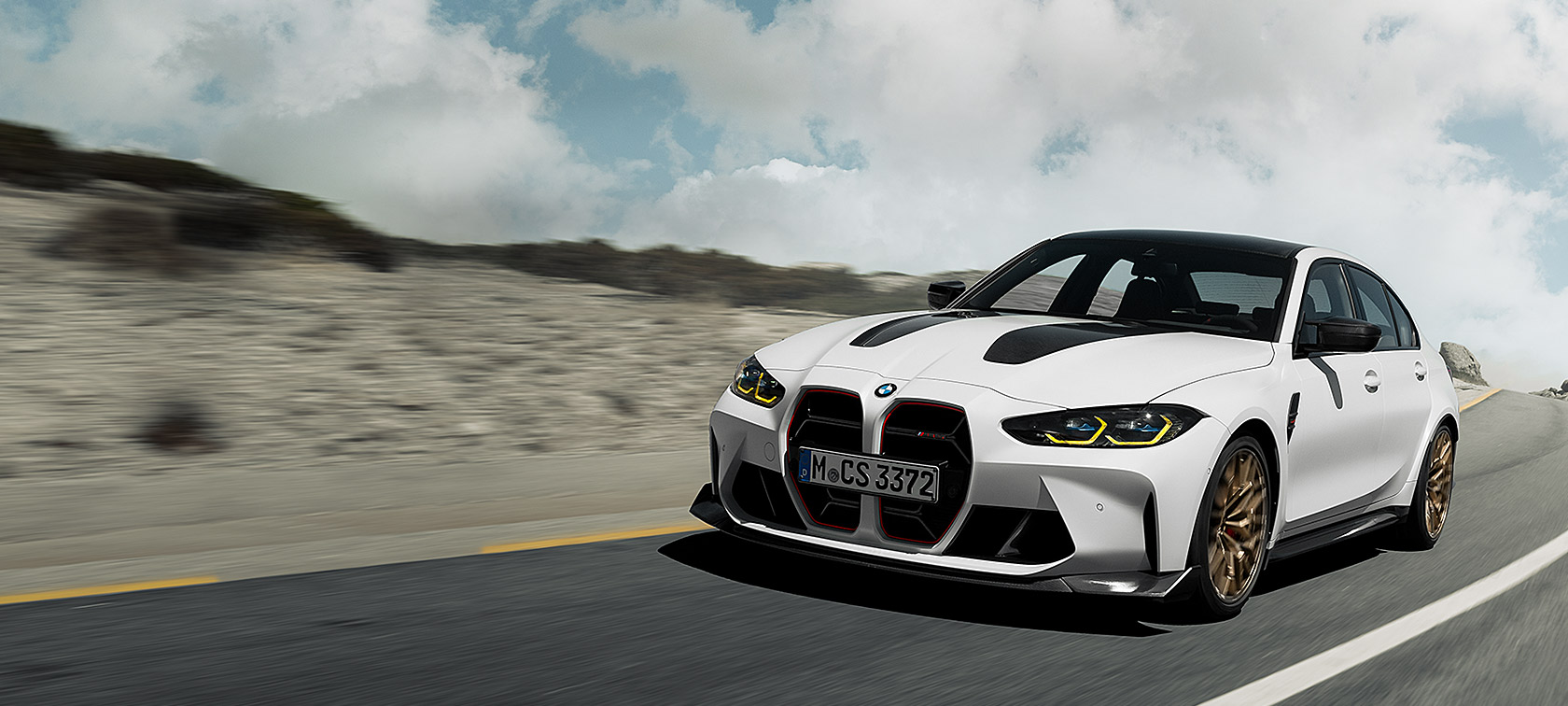 BMW M3 CS G80 three quarter front view driving on race track