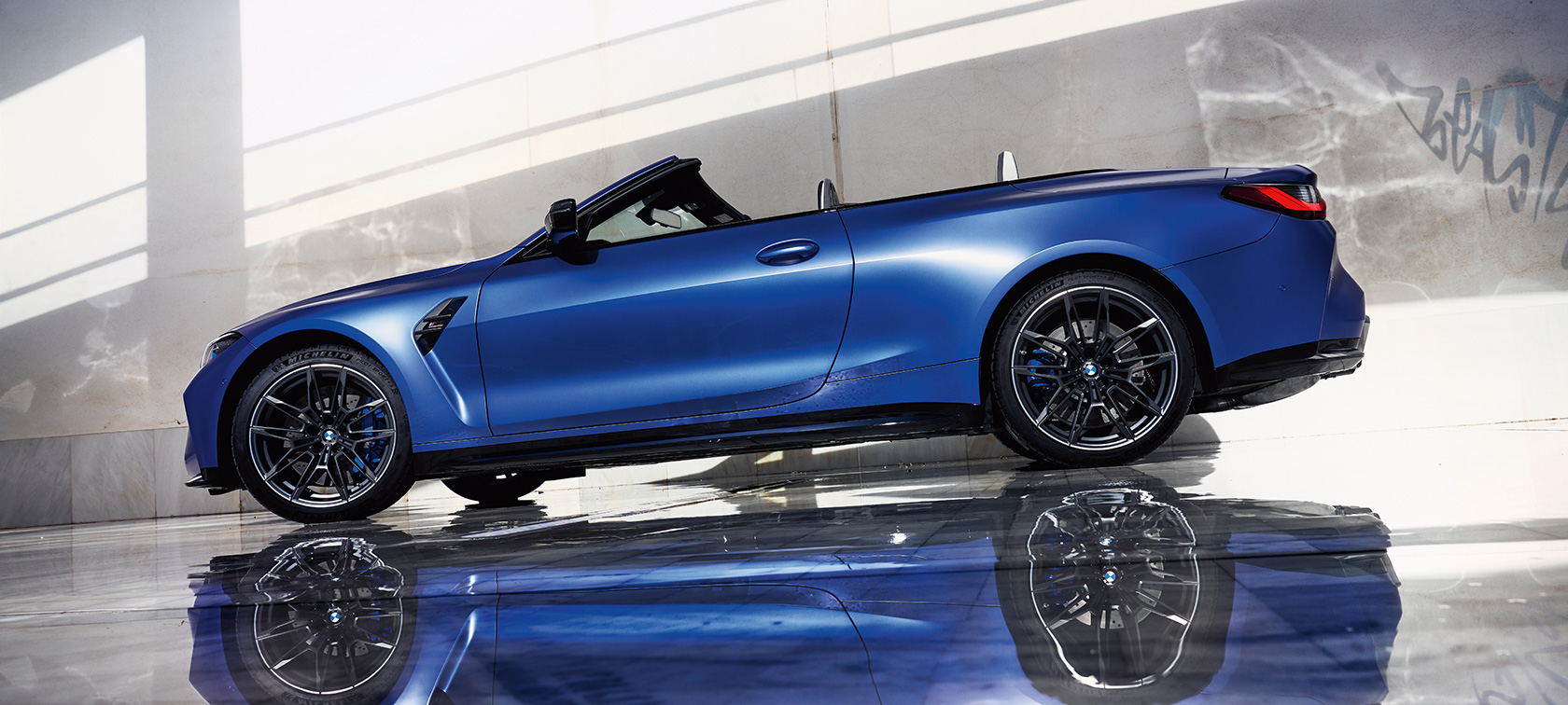 BMW M4 Competition Convertible with M xDrive G83 2021 BMW Individual Frozen Portimao Blue metallic side view standing low angle shot
