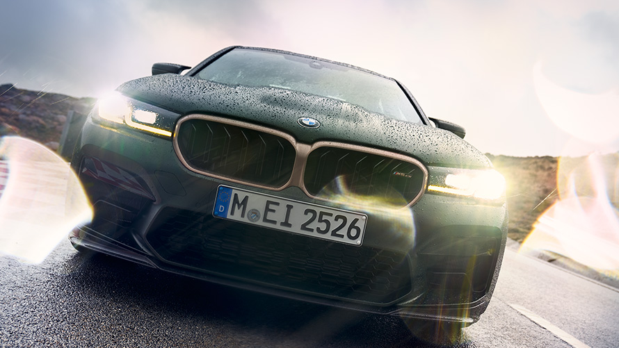 BMW M5 CS F90 2021 Frozen Deep Green metallic front view with headlights on