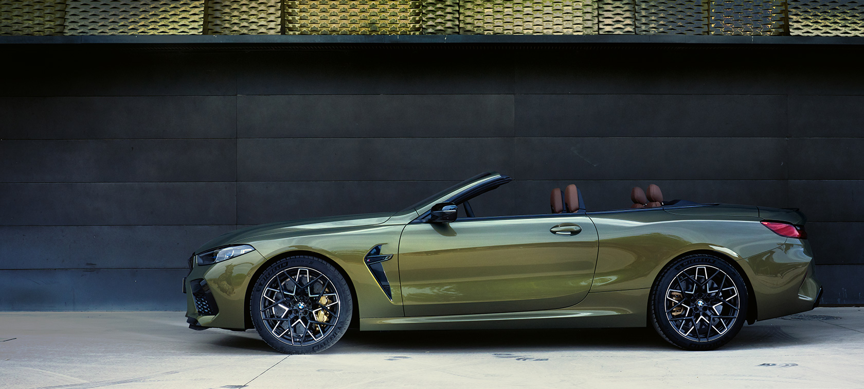 BMW M8 Competition Convertible F91 LCI Facelift 2022 BMW Individual Brass metallic side view standing with open door and female model