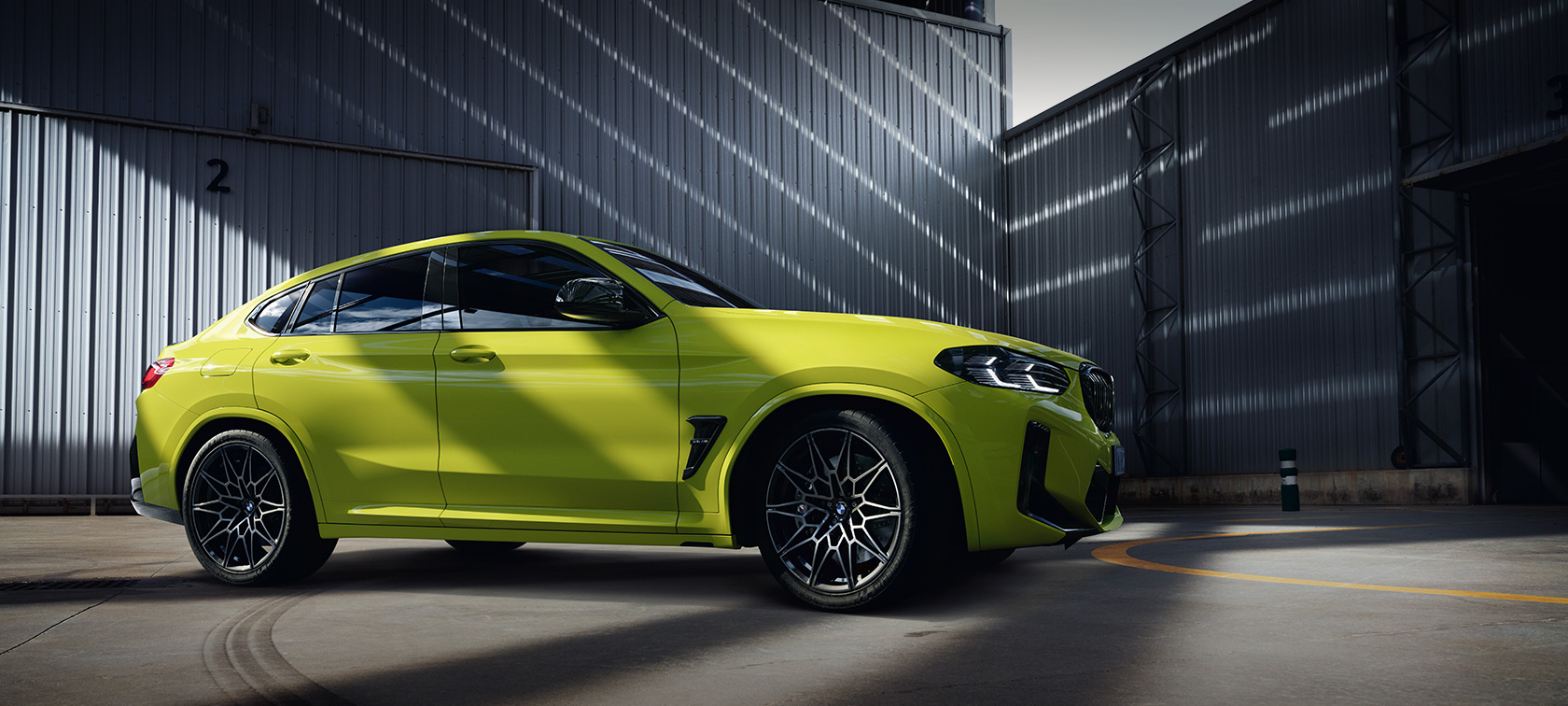 BMW X4 M Competition F98 LCI Facelift 2021 Sao Paulo Yellow side view in the hall