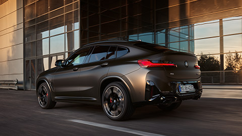 BMW X4 G02 second generation three-quarter side view driving on the street BMW X Series BMW X4 G02 second generation three-quarter side view driving on the street