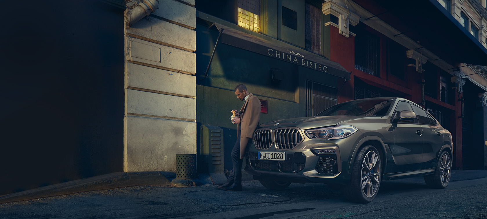BMW X6 G06 2019 Manhatten metallic three-quarter rear view driving