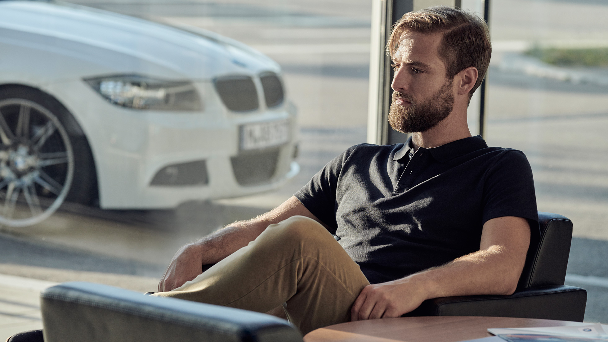 BMW Service BMW Service Inclusive BMW Service BMW Service Inclusive man sits relaxed at a BMW dealer