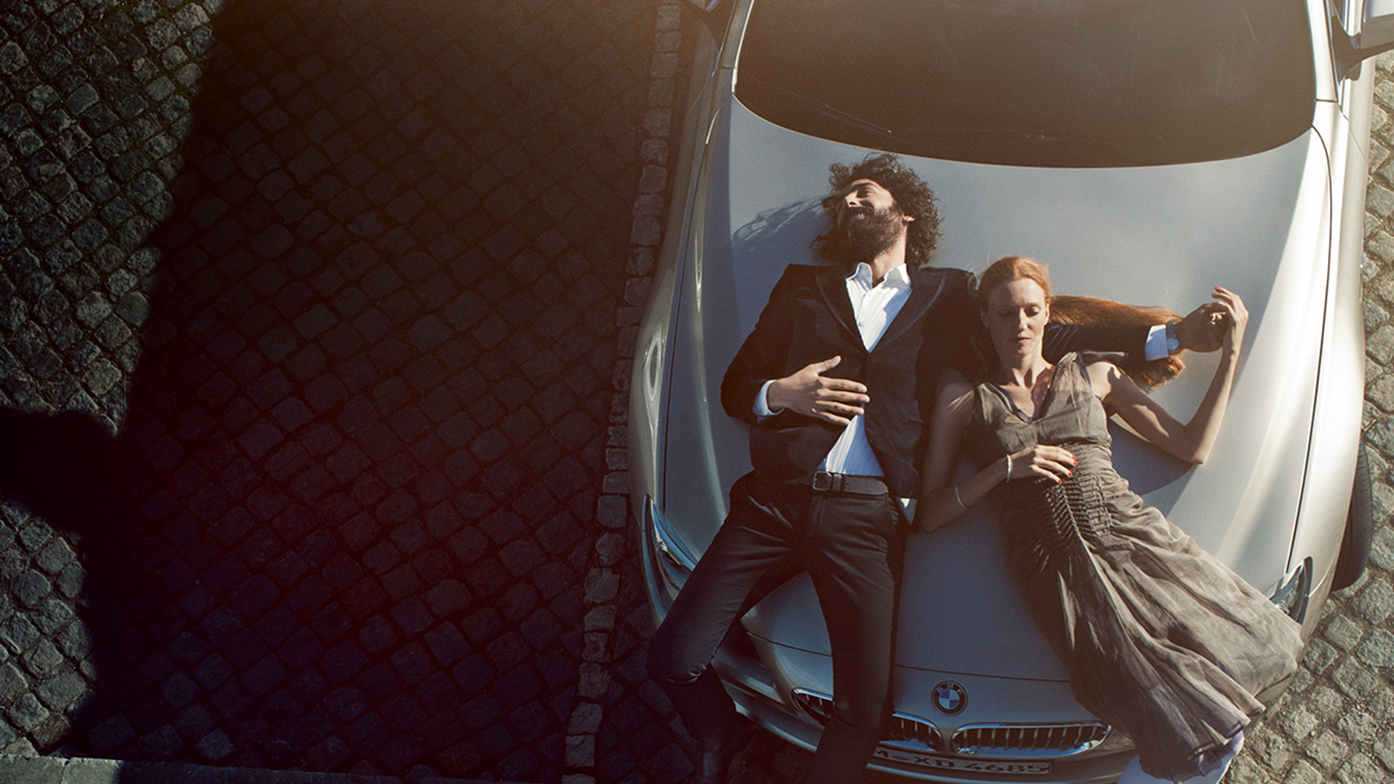 BMW Service BMW Engine Oil BMW Service BMW Engine Oil man and woman lying relaxed on the BMW bonnet