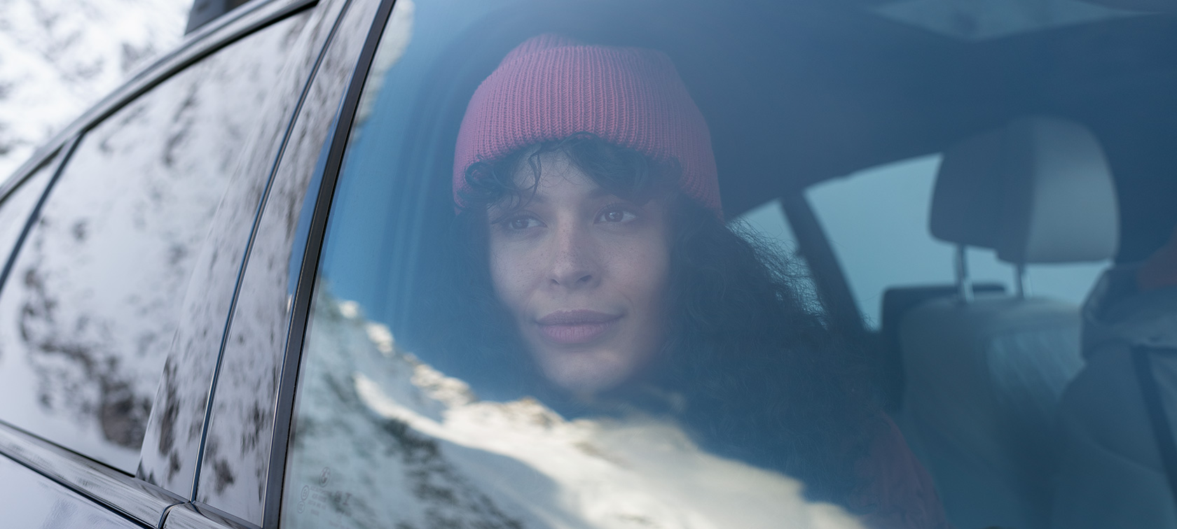 BMW Autumn Winter Accessories woman looking out of car window of a BMW